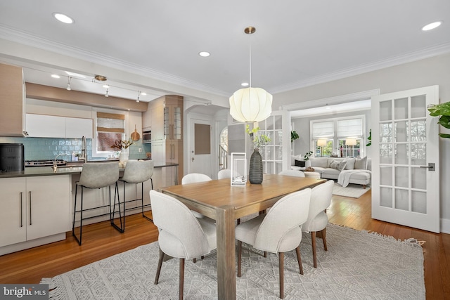 4619 Langdrum Ln, Chevy Chase, MD 20815 - dining area featuring recessed lighting, ornamental molding, and light wood-type flooring