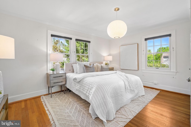 4619 Langdrum Ln, Chevy Chase, MD 20815 - bedroom featuring baseboards, ornamental molding, wood-type flooring, and multiple windows