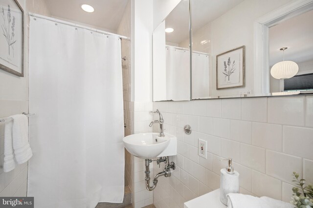 4619 Langdrum Ln, Chevy Chase, MD 20815 - full bathroom featuring a sink, tile walls, recessed lighting, and a shower with shower curtain