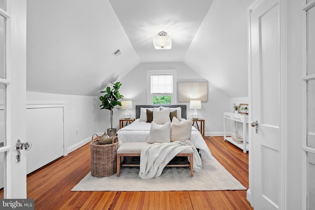 4619 Langdrum Ln, Chevy Chase, MD 20815 - bedroom featuring visible vents, wood finished floors, and lofted ceiling