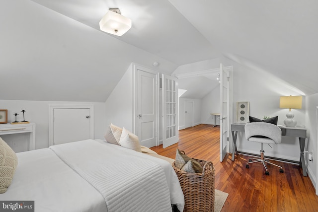 4619 Langdrum Ln, Chevy Chase, MD 20815 - bedroom with baseboards, vaulted ceiling, and wood finished floors