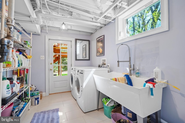 4619 Langdrum Ln, Chevy Chase, MD 20815 - laundry area with light tile patterned floors, a sink, a wealth of natural light, and washer and clothes dryer