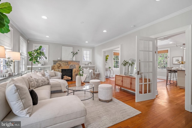 4619 Langdrum Ln, Chevy Chase, MD 20815 - living area featuring crown molding, a stone fireplace, recessed lighting, baseboards, and light wood-type flooring