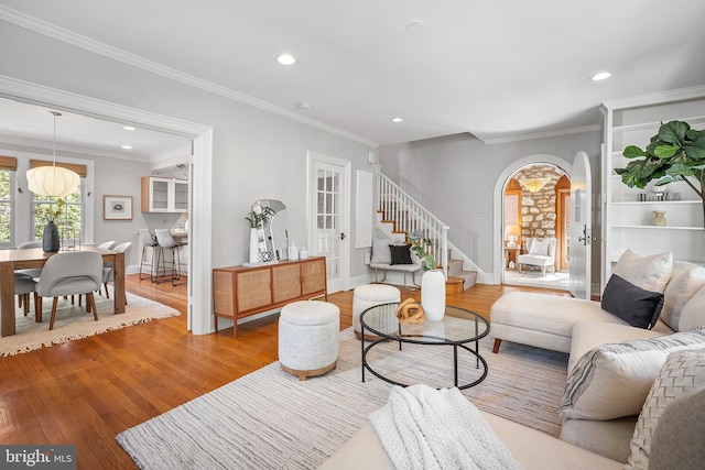4619 Langdrum Ln, Chevy Chase, MD 20815 - living room with crown molding, arched walkways, stairs, and wood finished floors