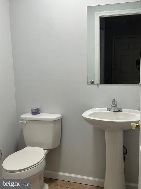 bathroom featuring tile patterned flooring and toilet