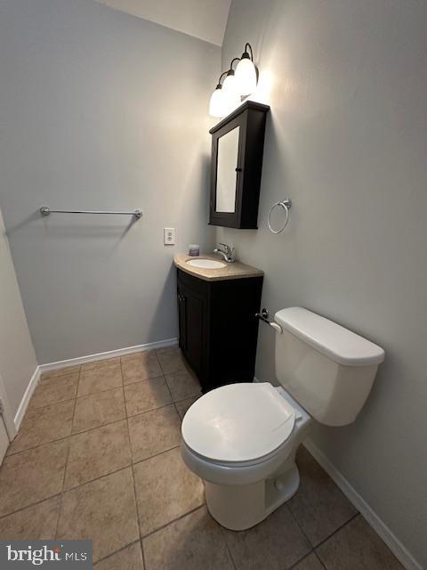 bathroom with tile patterned floors, vanity, and toilet