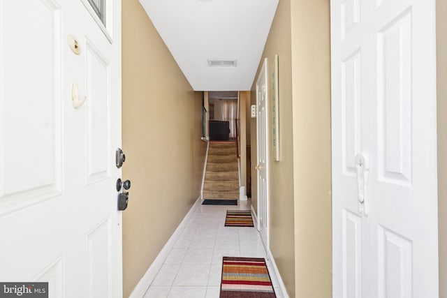 hall featuring light tile patterned floors