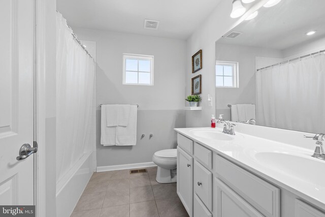 bathroom with vanity, tile patterned flooring, toilet, and plenty of natural light