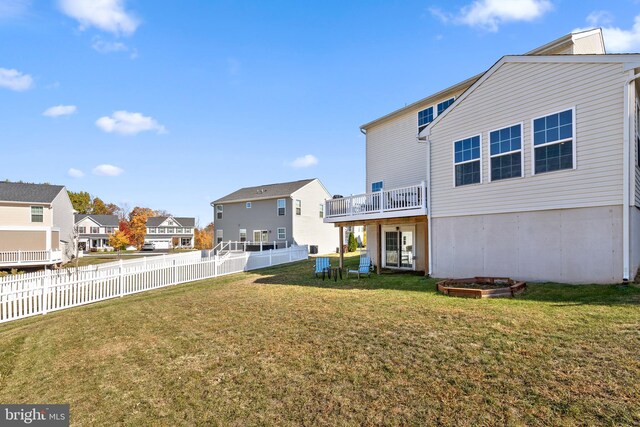 rear view of property featuring a lawn