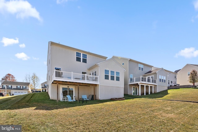 back of house featuring a deck and a lawn