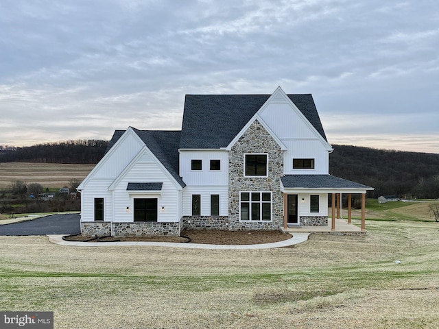 76 Long Ln, Kirkwood, PA 17536 - modern inspired farmhouse with stone siding, covered porch, a front yard, and board and batten siding