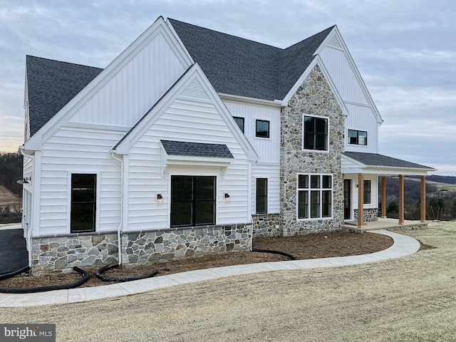 76 Long Ln, Kirkwood, PA 17536 - modern farmhouse style home with roof with shingles, a porch, stone siding, and board and batten siding