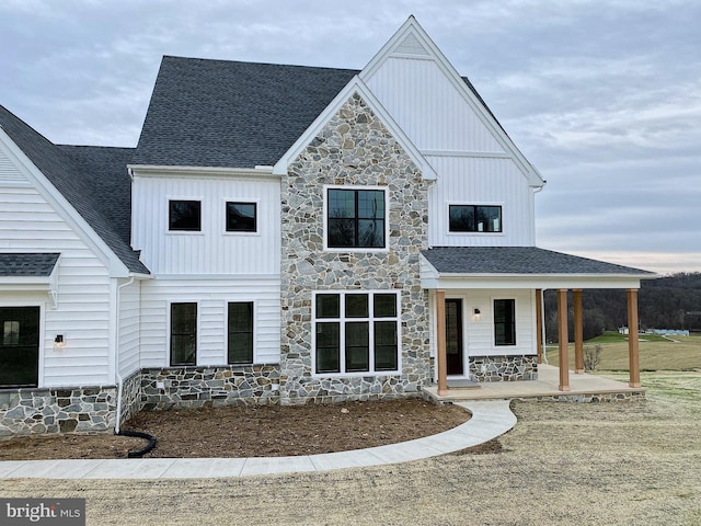 76 Long Ln, Kirkwood, PA 17536 - modern farmhouse featuring roof with shingles, a porch, stone siding, and board and batten siding