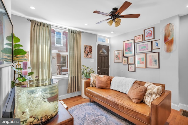 sitting room with light hardwood / wood-style flooring and ceiling fan