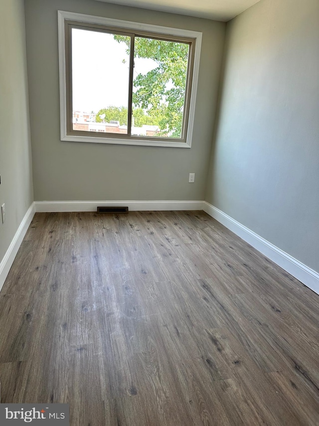 empty room with hardwood / wood-style flooring