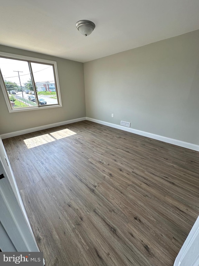 unfurnished room featuring dark hardwood / wood-style floors