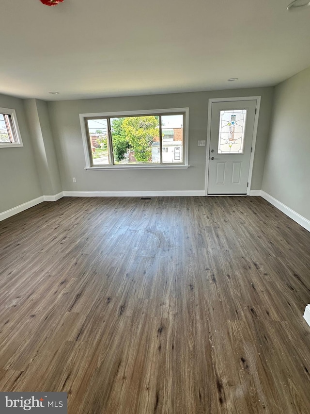 unfurnished living room with dark hardwood / wood-style floors