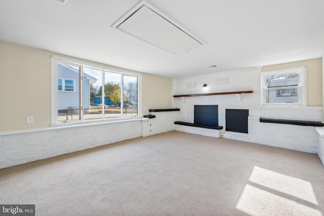 unfurnished living room featuring light carpet