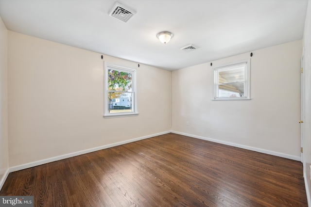 empty room with dark wood-type flooring