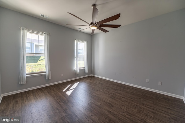 empty room with ceiling fan and dark hardwood / wood-style floors