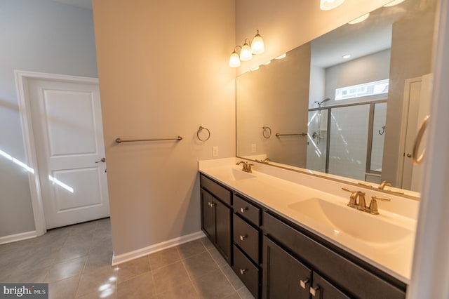 bathroom with vanity, tile patterned floors, and a shower with door