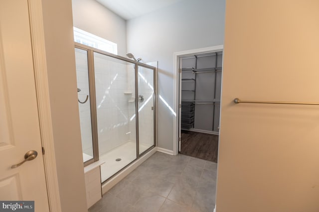 bathroom featuring tile patterned floors and an enclosed shower