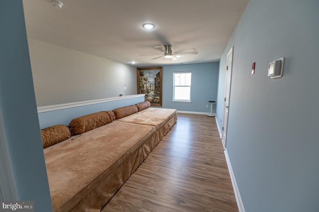 bedroom with wood-type flooring and ceiling fan