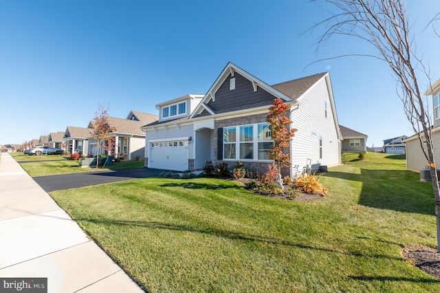 view of front of property with a garage, central AC, and a front lawn