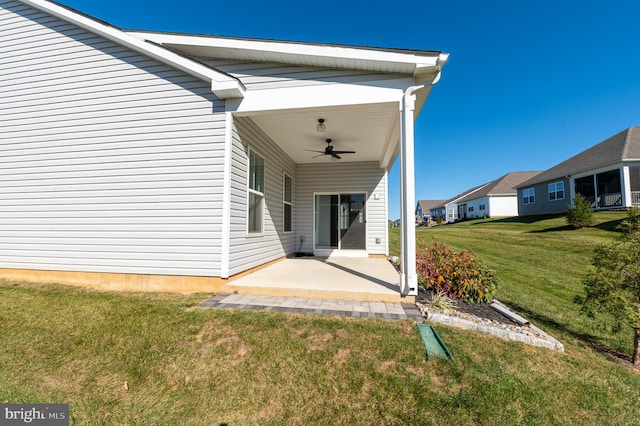 exterior space featuring a patio, ceiling fan, and a yard