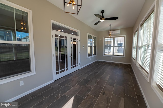 unfurnished sunroom with french doors and ceiling fan with notable chandelier