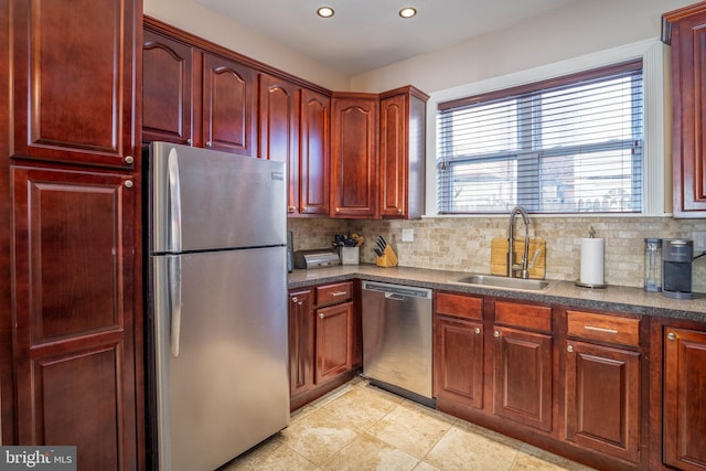 kitchen featuring appliances with stainless steel finishes, decorative backsplash, and sink