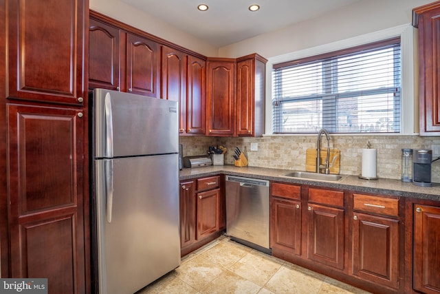 kitchen featuring a sink, recessed lighting, decorative backsplash, reddish brown cabinets, and appliances with stainless steel finishes