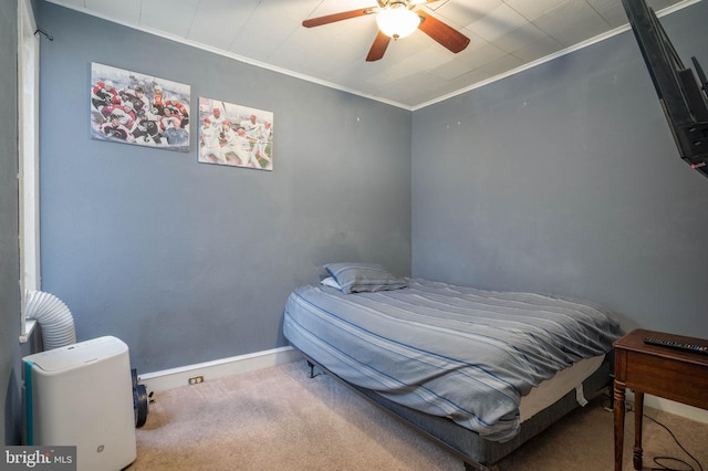 bedroom featuring ceiling fan, carpet, and ornamental molding