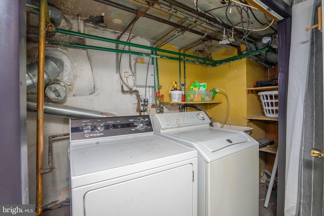clothes washing area featuring laundry area and washer and clothes dryer