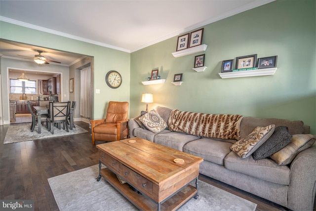 living room with ornamental molding, ceiling fan, and dark hardwood / wood-style flooring