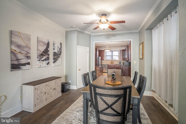 dining space with ornamental molding, dark wood-type flooring, and ceiling fan