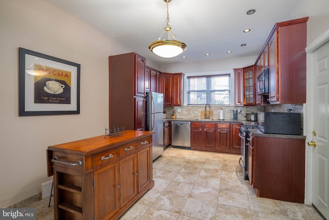 kitchen with tasteful backsplash, appliances with stainless steel finishes, sink, hanging light fixtures, and light tile patterned floors