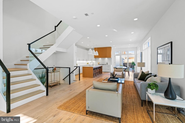 living room featuring light hardwood / wood-style floors and sink