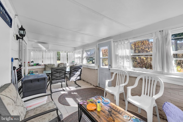 sunroom with lofted ceiling and a wall unit AC