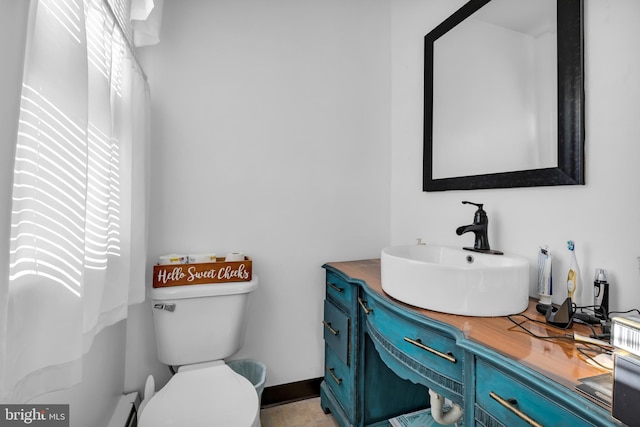 bathroom featuring toilet and vanity