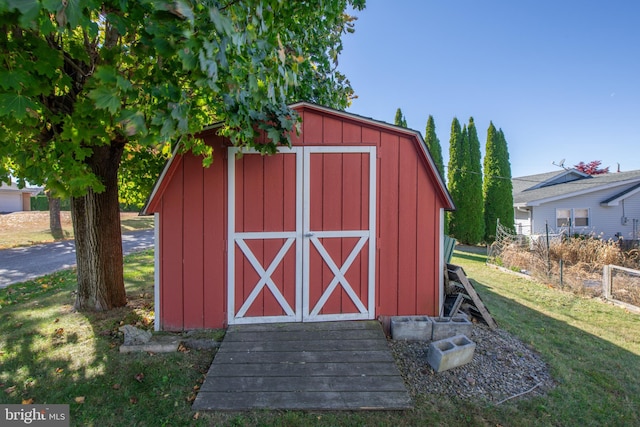 view of outdoor structure featuring a lawn