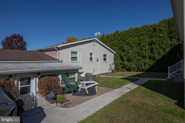 back of property featuring a yard and a patio area