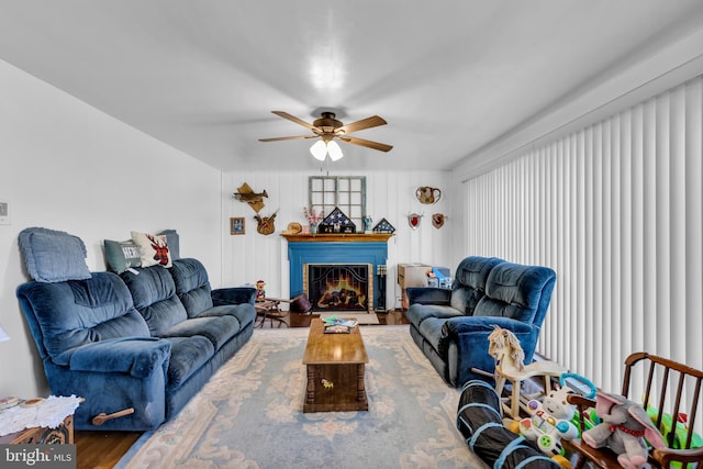 living room featuring wood-type flooring and ceiling fan