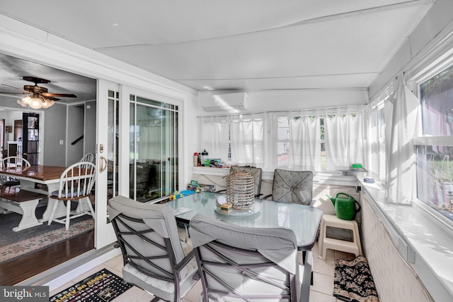 sunroom featuring lofted ceiling and ceiling fan