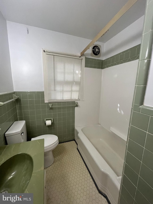 full bathroom featuring tile walls, tub / shower combination, vanity, and toilet