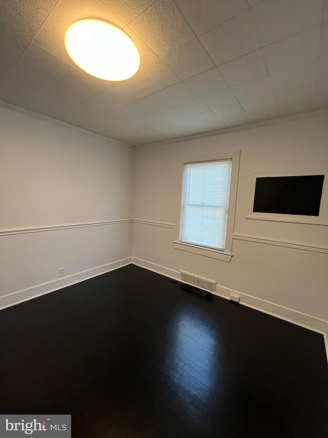 spare room featuring wood-type flooring