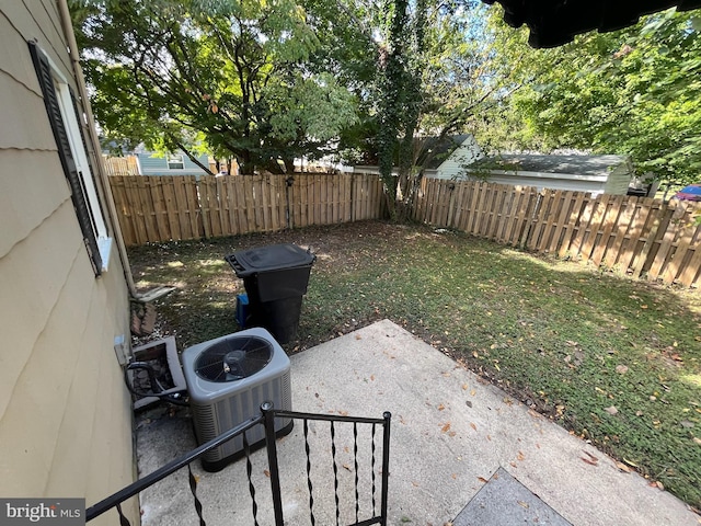 view of yard featuring central air condition unit and a patio