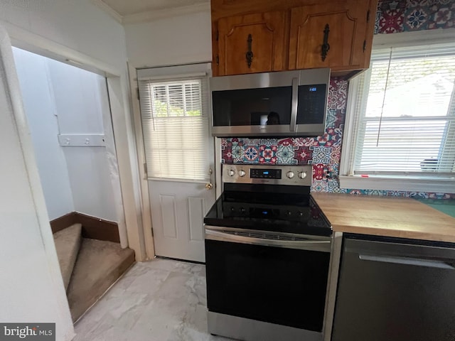 kitchen featuring crown molding and appliances with stainless steel finishes