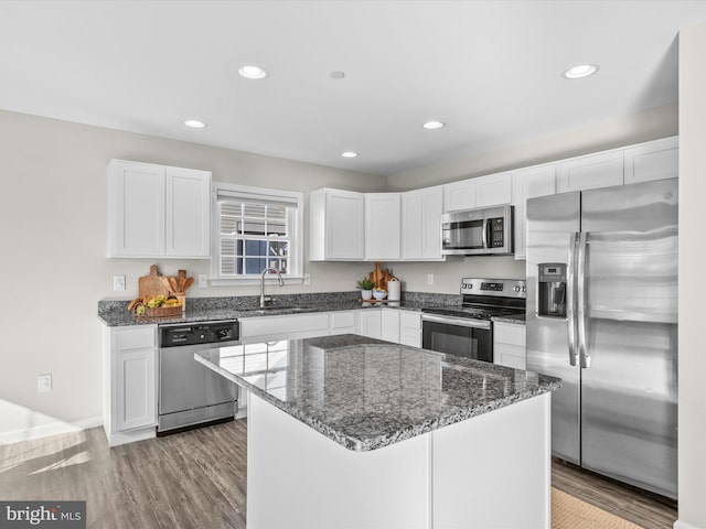 kitchen featuring sink, appliances with stainless steel finishes, a kitchen island, and white cabinets