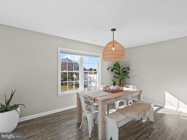 dining space with dark hardwood / wood-style flooring